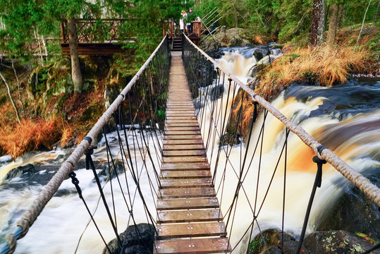 Suspended pedestrian bridge over a waterfall on the Tohmajoki river.