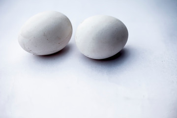Fototapeta na wymiar Two eggs or ovums isolated on white of hen.