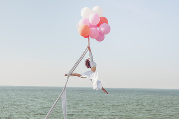 Young woman hovers in the air.