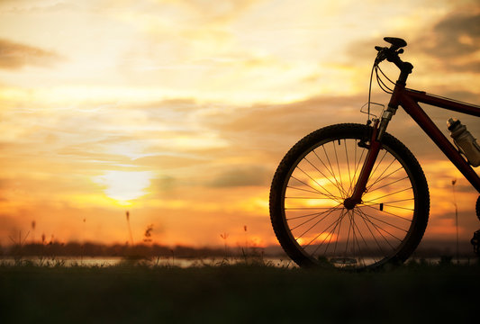 Silhouette bicycle with sunset or sunrise background