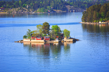 Finland, small red houses on an island in the Baltic Sea