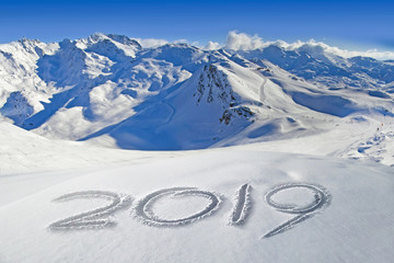 2019 written in the snow, mountain landscape in the background