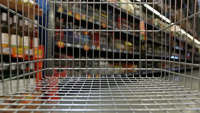 Empty shopping cart moving through supermarket