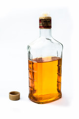 Scotch or whisky or whiskey bottle isolated on white with half filled in it,Close up view along with top shot.