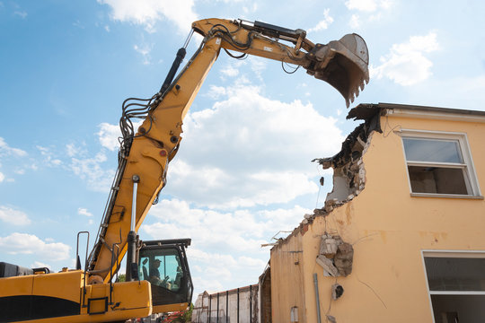 demolition of a house by an excavator