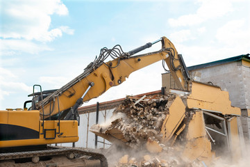 demolition of a house by an excavator