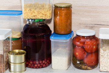 Storage shelves in pantry with homemade canned preserved fruits and vegetables