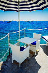Chairs under umbrella, beautiful details of Positano coast, italian resort, Italy, retro toned
