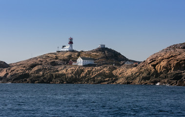 Navigation at sea. Lighthouse on a cliff. Norway. North Sea archipelago