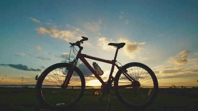 Time lapse silhouette bicycle with sunset  background 