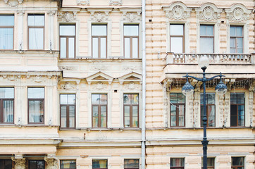 Saint Petersburg, RUSSIA - July 08, 2018: Fragment of a building facade with windows. Beautiful architecture of the city of St. Petersburg, Russia.