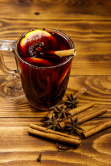 Mulled wine and spices on wooden table