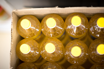 Many bottles of sunflower oil in box.