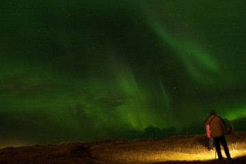 Obraz na płótnie Canvas watching aurora borealis during autumn night, Iceland
