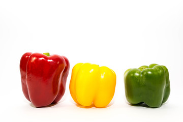 Three peppers in three color close up shot isolated on white background.