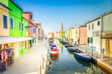 Fototapeta na wymiar colorful rows of houses and boats of Burano island at sunny day, Venice, Italy, retro toned