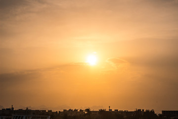Fototapeta premium Beautiful sunset in the tropic city. City skyline at sunset.