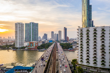 Naklejka premium Aerial view of Bangkok city at evening, Chaopraya River, bangkok, Thailand