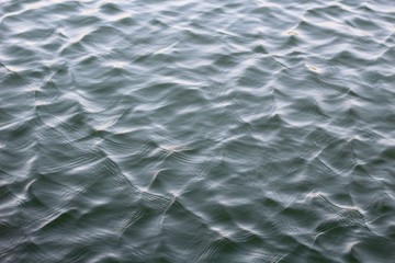 The wave and ripple pattern on the water surface.