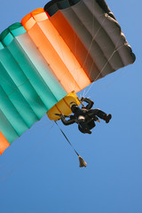 Parachute landing. Skydiver with a bright parachute closeup.