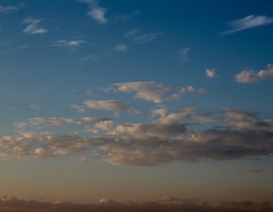 The mix of white and gray in the morning blue sky.