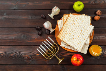 Jewish holiday Passover banner design with wine, matzo on wooden background.