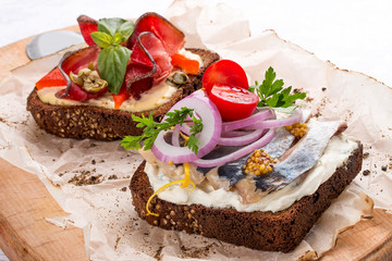 Toasts with venison, pepper and capers, herring and ricotta cheese