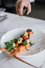 Tasty Phuket lobster with black spaghetti and tomato