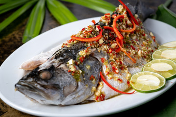 Fototapeta na wymiar Favourite seafood of Thailand, steamed white snapper with lemon sauce.