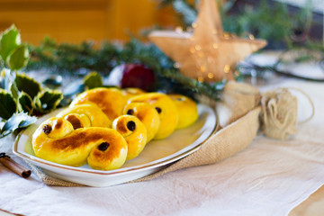 Typcial traditional Swedish saffron buns for the Christmas holidays and Ludia Day in December called "Lucia buns" or also "Lussekatter".  Selective focus