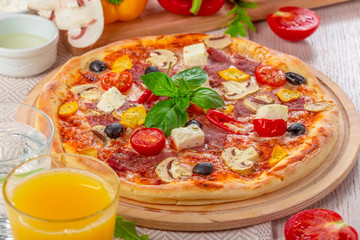 Pizza with Mozzarella, Ham, Cherry Tomatoes, Black Olives