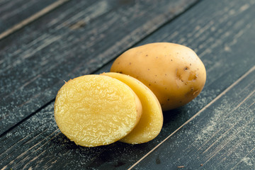 Fresh potatoes on the wood background