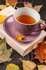 Autumn leaves, book and cup of tea