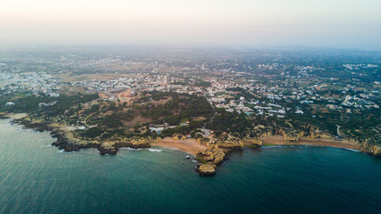 Naklejka premium Aerial view of sunset on the coast Algarve, Portugal. Concept for above Albufeira region beach of Portugal. Summer vacations