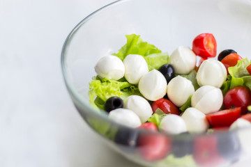Vegetable salad with cherry tomato, olives and mozarella