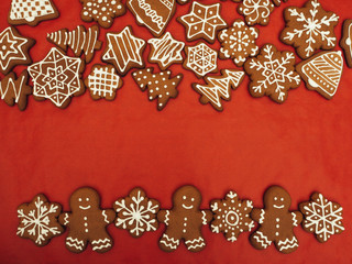 Happy New Year and Merry Christmas gingerbread on red background. Christmas baking. Making gingerbread christmas cookies. Christmas concept.