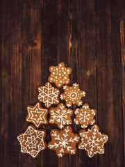 Happy New Year and Merry Christmas gingerbread on wood background. Christmas baking. Making gingerbread christmas cookies. Christmas concept.