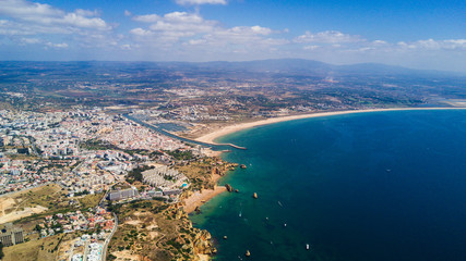 Naklejka premium Aerial view of beautiful cliffs and beach near Lagos city in Algarve coast at Portugal