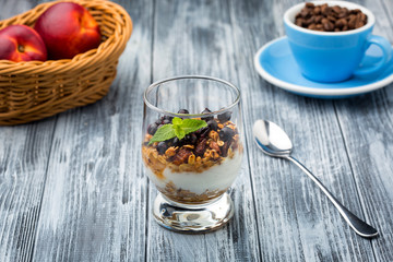 Homemade granola in glass with yogurt and berries