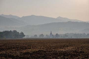 mountain top panorama in  autumn covered in mist or clouds