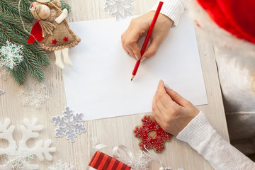 Female hand holding a letter to Santa 