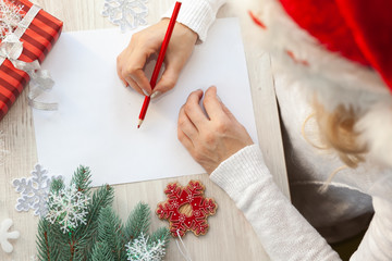 Female hand holding a letter to Santa 