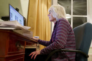 Old elderly senior person learning computer and online internet skills 
