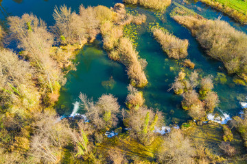 Obraz premium Croatia, Mreznica river from air, drone shoot, top down view, Karlovac county, green nature, wood and waterfalls in autumn