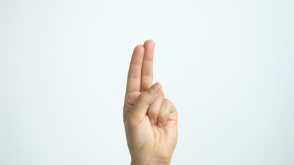 Close up of isolated female hand shows two fingers up isolated on white background