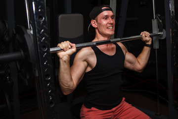 Fototapeta na wymiar young man trains his back in the gym.