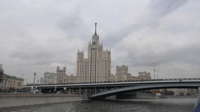 Stalin Vysotka on Kotelnicheskaya embankment view from Moscow river. Late autumn in the capital's quays. Navigable walking river.