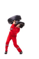 Young garage worker with tyre isolated on white