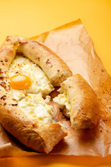 Khachapuri with cheese on yellow