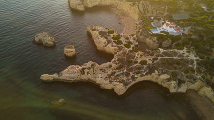 Aerial view of sunset over the coast Algarve coast, Portugal. Concept for above beach of Portugal. Summer vacations